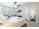 Bright bedroom with neutral walls, ceiling fan, and multiple windows providing natural light at 539 Treviso Dr, Apollo Beach, FL 33572