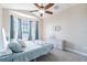 Bright bedroom featuring blue accent colors, bay windows, and comfortable decor at 539 Treviso Dr, Apollo Beach, FL 33572