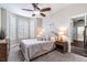 Cozy bedroom featuring natural light, ceiling fan, and en-suite bathroom at 539 Treviso Dr, Apollo Beach, FL 33572
