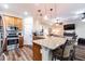 Open kitchen with granite countertops, modern appliances, and seating area connected to the living room at 539 Treviso Dr, Apollo Beach, FL 33572