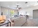 Bright living area with a ceiling fan, comfortable seating, desk and balcony access with plenty of natural light at 539 Treviso Dr, Apollo Beach, FL 33572