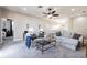 Spacious and cozy living area with plush carpeting, comfortable seating, ceiling fan, and serene decor at 539 Treviso Dr, Apollo Beach, FL 33572