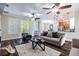 Comfortable living room features wood floors, modern furniture, ceiling fans, and ample natural light at 539 Treviso Dr, Apollo Beach, FL 33572