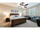 Serene main bedroom featuring a ceiling fan, plush carpeting, cozy seating area, and shuttered windows at 539 Treviso Dr, Apollo Beach, FL 33572