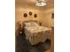 Cozy bedroom featuring a wicker headboard, side tables with lamps, and tropical decor at 5720 Palmer Cir # 102, Bradenton, FL 34211