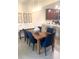 Inviting dining room with wood table, stylish blue chairs, and a decorative light fixture creating a cozy atmosphere at 5720 Palmer Cir # 102, Bradenton, FL 34211