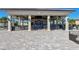 Outdoor bar area with barstool seating and mounted televisions at 5720 Palmer Cir # 102, Bradenton, FL 34211