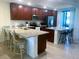 Well-equipped kitchen featuring granite countertops, a central island with breakfast bar, and modern appliances at 5720 Palmer Cir # 102, Bradenton, FL 34211