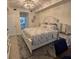Comfortable main bedroom with a decorative rug, a nightstand, and an en-suite bathroom in the background at 5720 Palmer Cir # 102, Bradenton, FL 34211