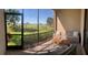Screened-in patio with a comfortable seating area and views of the green landscape at 5720 Palmer Cir # 102, Bradenton, FL 34211