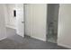 Bedroom featuring neutral carpet and a view of an ensuite bathroom at 6427 2Nd S Ave, St Petersburg, FL 33707