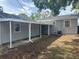 Back exterior view of the home with a breezeway connecting the main house to the garage at 6427 2Nd S Ave, St Petersburg, FL 33707
