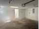 Garage with open door, concrete floor, and a door leading to the home at 6427 2Nd S Ave, St Petersburg, FL 33707