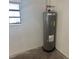 Garage featuring a hot water heater and a window at 6427 2Nd S Ave, St Petersburg, FL 33707