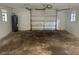 Garage with open door, concrete floor, and hot water tank at 6427 2Nd S Ave, St Petersburg, FL 33707