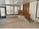 Sunroom with concrete floor, many windows, and stairs with wood railing at 6427 2Nd S Ave, St Petersburg, FL 33707
