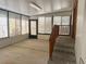 Sunroom with concrete floor, many windows, and stairs with wood railing at 6427 2Nd S Ave, St Petersburg, FL 33707