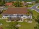 Scenic aerial view showcasing the lush backyard with the home and the well manicured landscaping at 702 Plumbrook Rd, Sun City Center, FL 33573