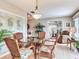 Cozy dining area with wicker chairs, glass table, and views into living area with neutral decor at 702 Plumbrook Rd, Sun City Center, FL 33573
