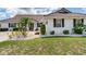 Attractive home with manicured lawn, professional landscaping, and a tile roof at 702 Plumbrook Rd, Sun City Center, FL 33573