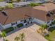Inviting single-story home with a tile roof, well-manicured landscaping, and a spacious driveway leading to an attached garage at 702 Plumbrook Rd, Sun City Center, FL 33573