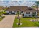 Beautiful single-story home featuring a well-manicured lawn and tile roof at 702 Plumbrook Rd, Sun City Center, FL 33573