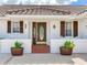 Inviting front entrance with brick landing and decorative planters at 702 Plumbrook Rd, Sun City Center, FL 33573
