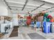 Spacious two car garage with storage cabinets and a bicycle parked inside, providing ample space for parking and hobbies at 702 Plumbrook Rd, Sun City Center, FL 33573