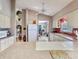 Bright kitchen with island cooktop, lots of storage, and adjacent living area at 702 Plumbrook Rd, Sun City Center, FL 33573