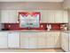 Charming kitchen with custom white cabinets and plenty of counter space at 702 Plumbrook Rd, Sun City Center, FL 33573