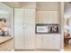 Kitchen with ample storage including pantry cabinets and a built-in microwave at 702 Plumbrook Rd, Sun City Center, FL 33573