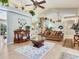 Spacious living room featuring decorative accents, hardwood floors, and an open layout at 702 Plumbrook Rd, Sun City Center, FL 33573