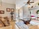 Bright living room with ample seating, hardwood floors, and modern decor at 702 Plumbrook Rd, Sun City Center, FL 33573