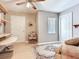 Living room featuring a large rug, accent chair, and a door leading to another room at 702 Plumbrook Rd, Sun City Center, FL 33573