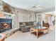 Inviting living room with stone fireplace, comfortable seating, and open layout at 702 Plumbrook Rd, Sun City Center, FL 33573