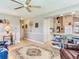 Open concept living room is adjacent to the kitchen and breakfast bar at 702 Plumbrook Rd, Sun City Center, FL 33573