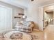 Living room showing a patterned loveseat and a large rug with doors leading to other rooms at 702 Plumbrook Rd, Sun City Center, FL 33573