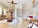 Inviting living room with glass table, ceiling fan and lots of natural light at 702 Plumbrook Rd, Sun City Center, FL 33573