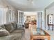 Comfortable living room with seating and views through french doors into dining room at 702 Plumbrook Rd, Sun City Center, FL 33573