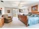 Spacious main bedroom with a sleigh bed, sitting area, and dresser with TV at 702 Plumbrook Rd, Sun City Center, FL 33573