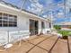 Screened-in patio with views of the exterior of the house and a small table at 702 Plumbrook Rd, Sun City Center, FL 33573
