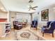 Comfortable sitting area with ceiling fan, lots of natural light, and easy access to kitchen at 702 Plumbrook Rd, Sun City Center, FL 33573