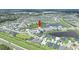 Wide aerial shot showcases the community layout, highlighting the neighborhood's location near a pond at 7201 Talamore Dr, Wesley Chapel, FL 33545