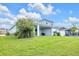 Beautiful backyard with a covered patio, lush lawn, and well-maintained landscaping at 7201 Talamore Dr, Wesley Chapel, FL 33545