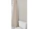 Bathroom featuring a toilet and a neutral shower curtain for a minimalist design at 7201 Talamore Dr, Wesley Chapel, FL 33545