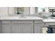 Bathroom featuring gray cabinets, sleek countertops, and a modern sink fixture at 7201 Talamore Dr, Wesley Chapel, FL 33545