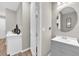 Well-lit bathroom featuring a stylish vanity and a round decorative mirror at 7201 Talamore Dr, Wesley Chapel, FL 33545