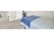 Bedroom featuring carpet, a blue and white bed, and a view of the hallway at 7201 Talamore Dr, Wesley Chapel, FL 33545
