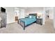 Well-lit primary bedroom boasts carpeted floors and a calming blue color scheme at 7201 Talamore Dr, Wesley Chapel, FL 33545