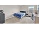 Bedroom with carpet floors, a blue bed, and natural light for a comfortable vibe at 7201 Talamore Dr, Wesley Chapel, FL 33545
